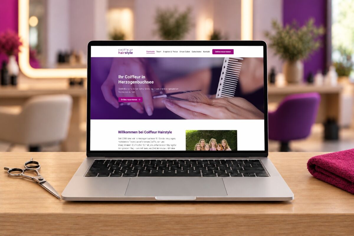 Offener Laptop auf Holztisch zeigt Website mit Haarschnitt-Demo und Text «By Coiffeur in Herzogenbuchsee» sowie «MitBommeln